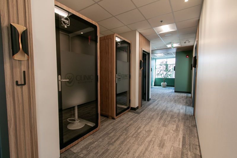 Two private pods with frosted glass doors along the hallway